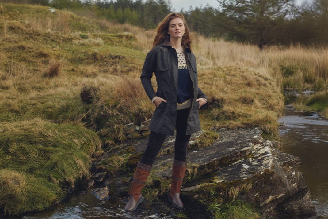 Girl stands in a river in Scotland