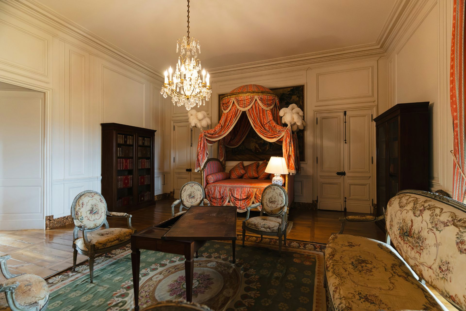 Bedroom with four poster bed and chandelier