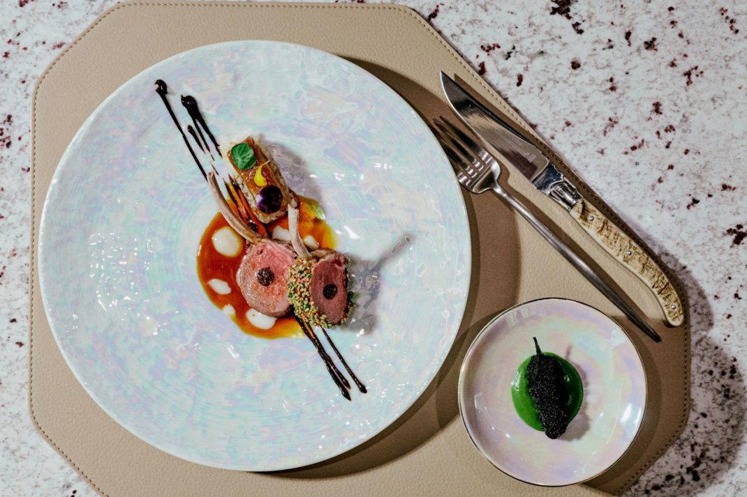 Korean tasting menu on a taupe leather placemat