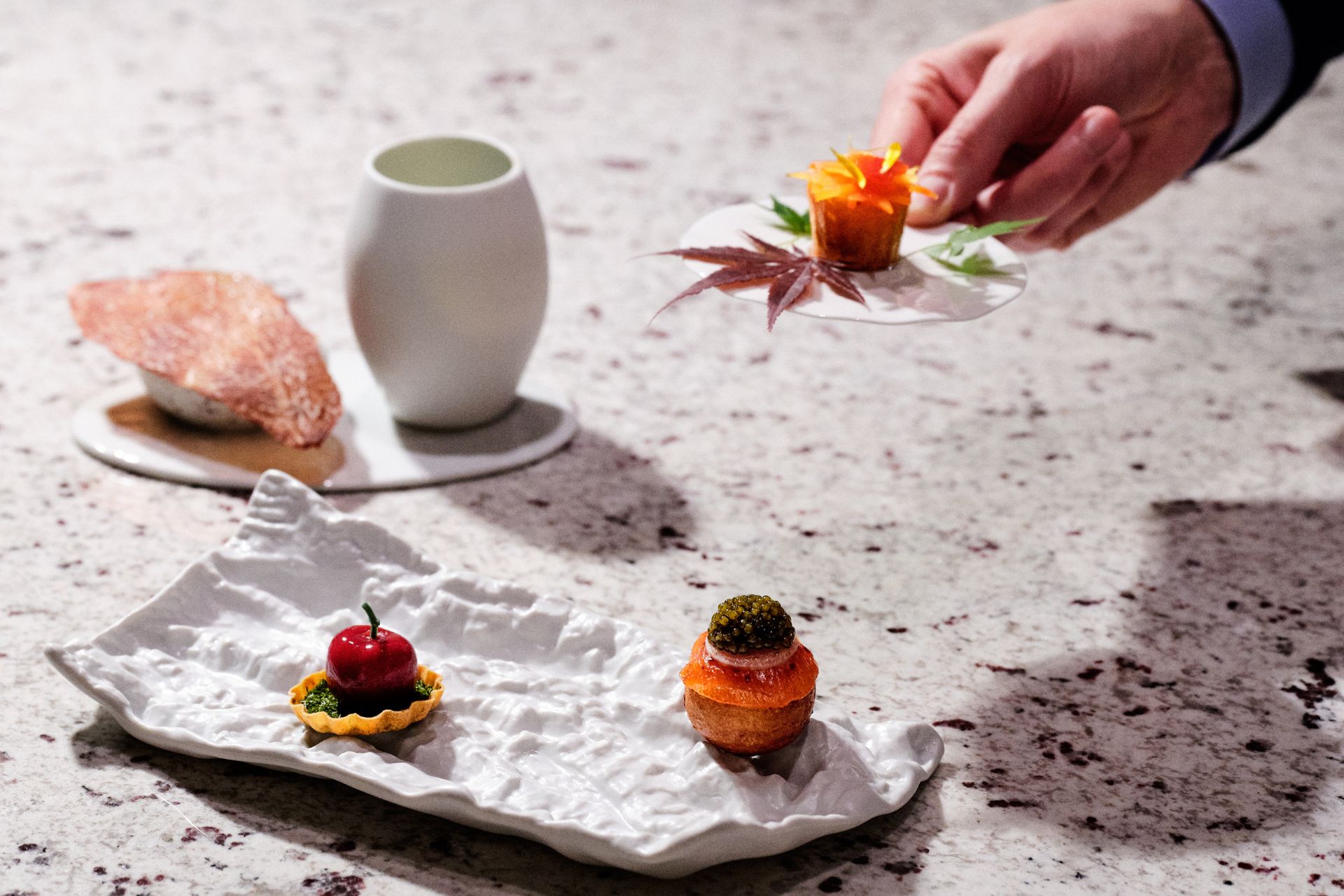 Stone counter with ceramic tray of canapes