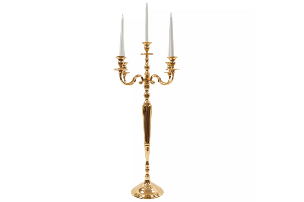 Gold candelabra with three white tapered candles