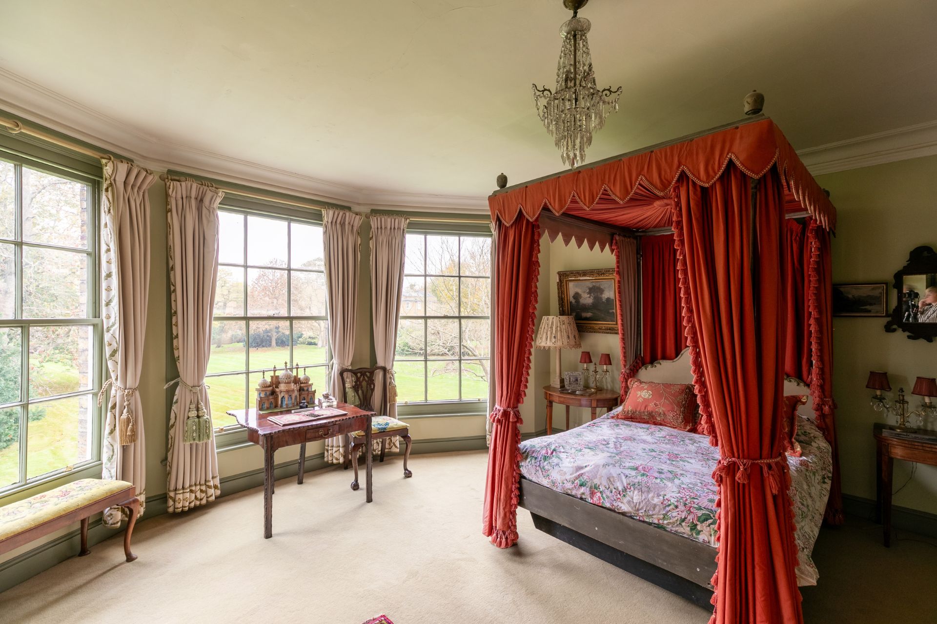 Bedroom with four poster bed and chandelier
