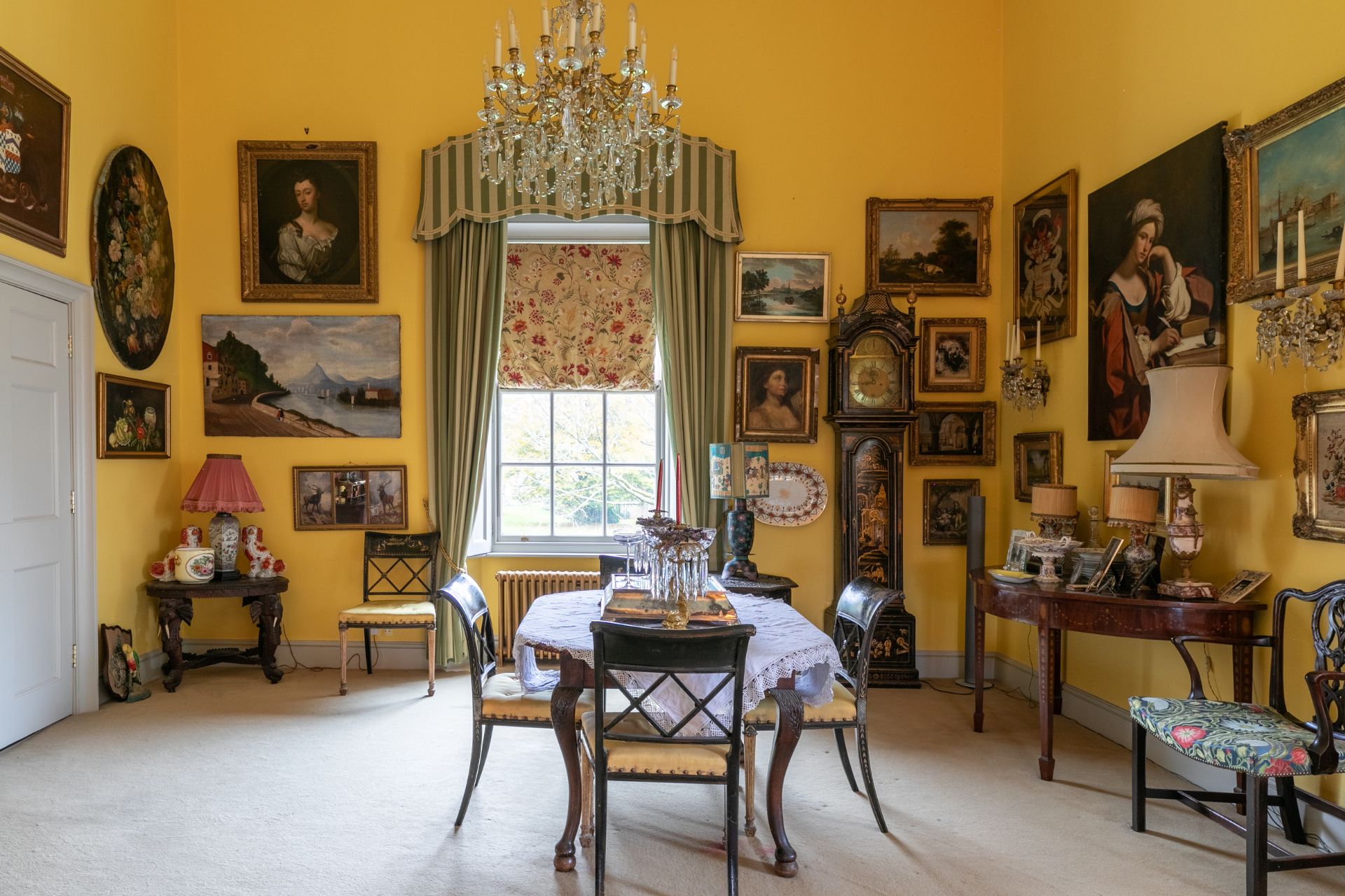 Yellow dining room with antique furniture