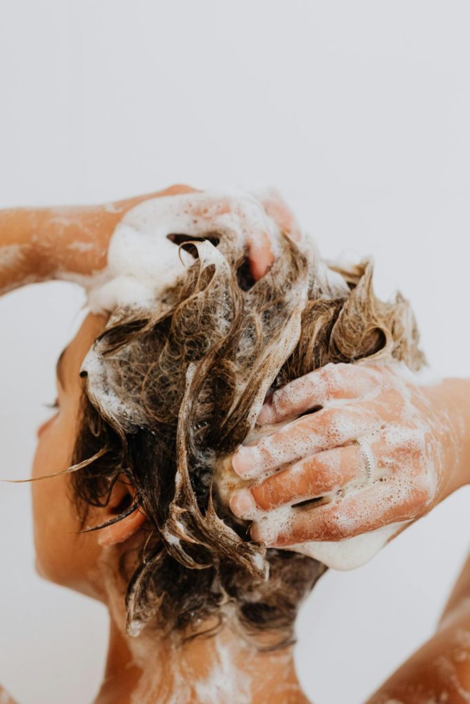Blonde woman washing her hair