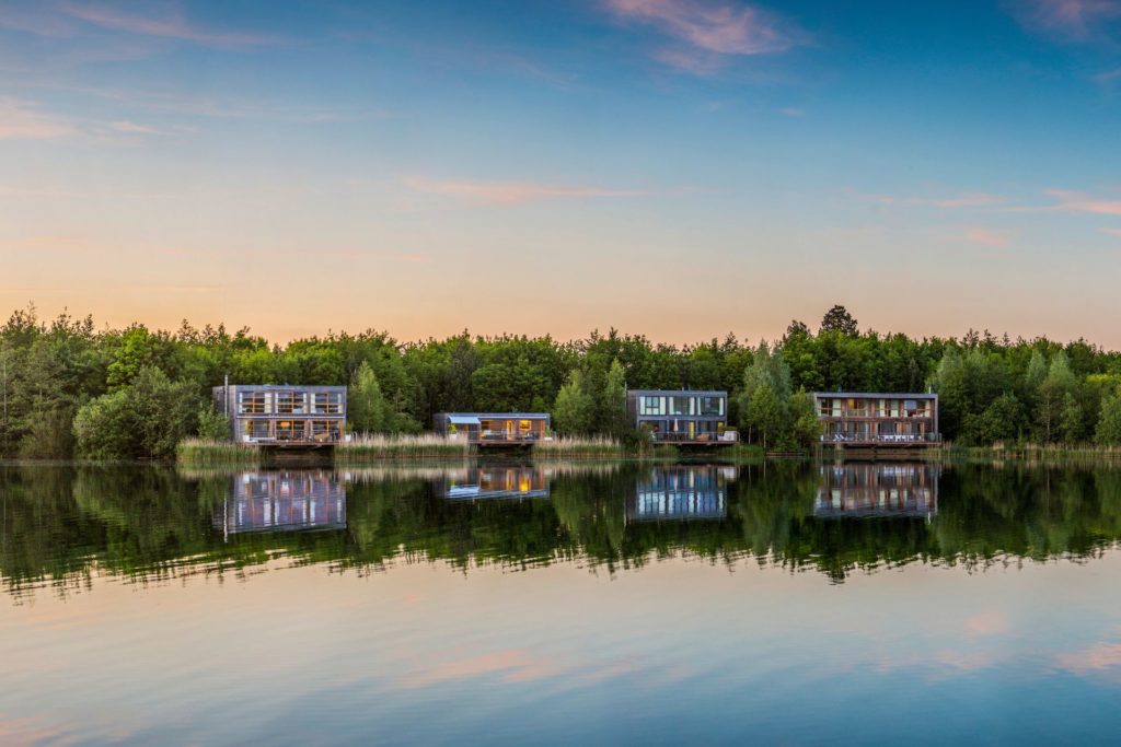 Modern lakeside cabins at sunset