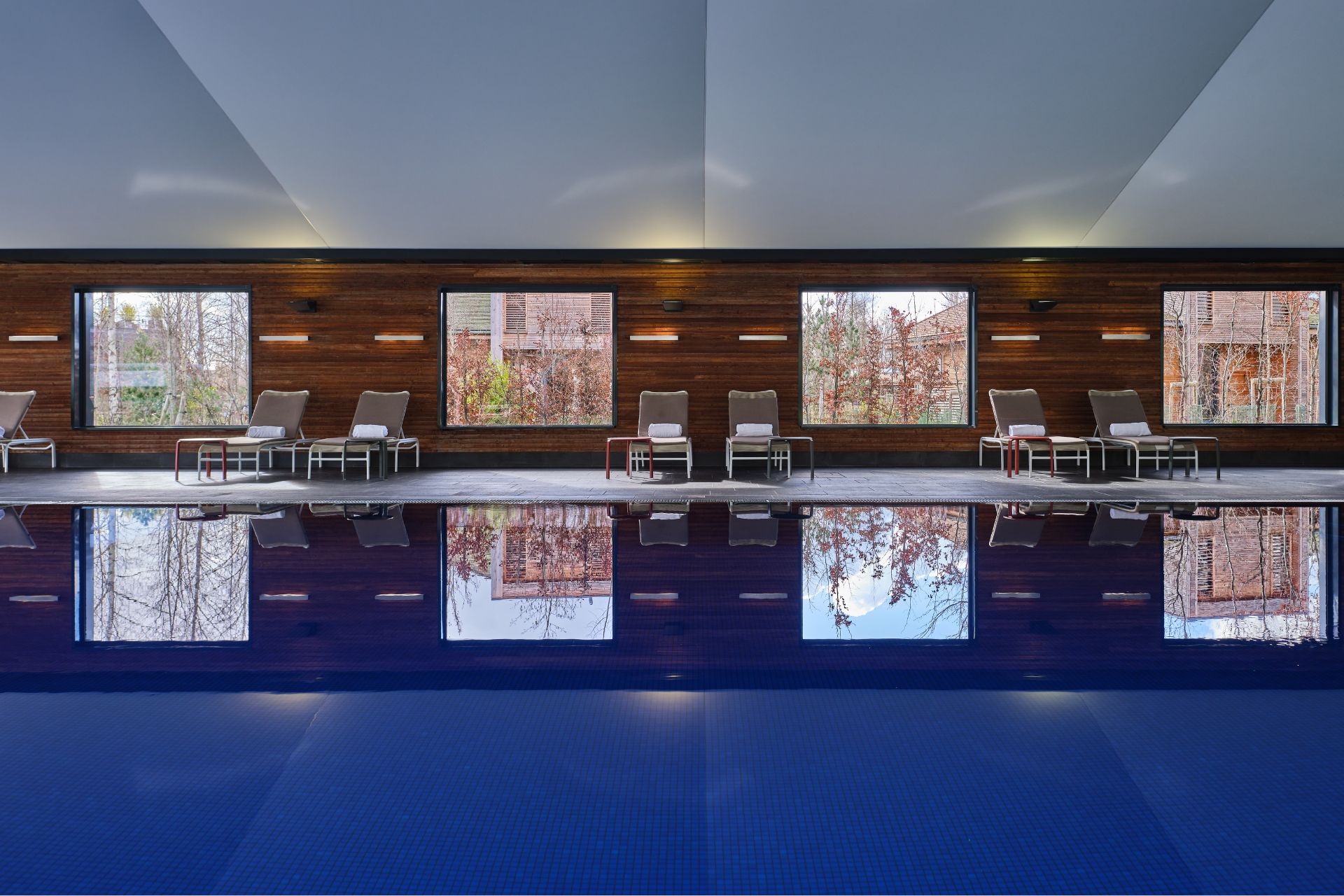 Indoor pool with wood panelled wall