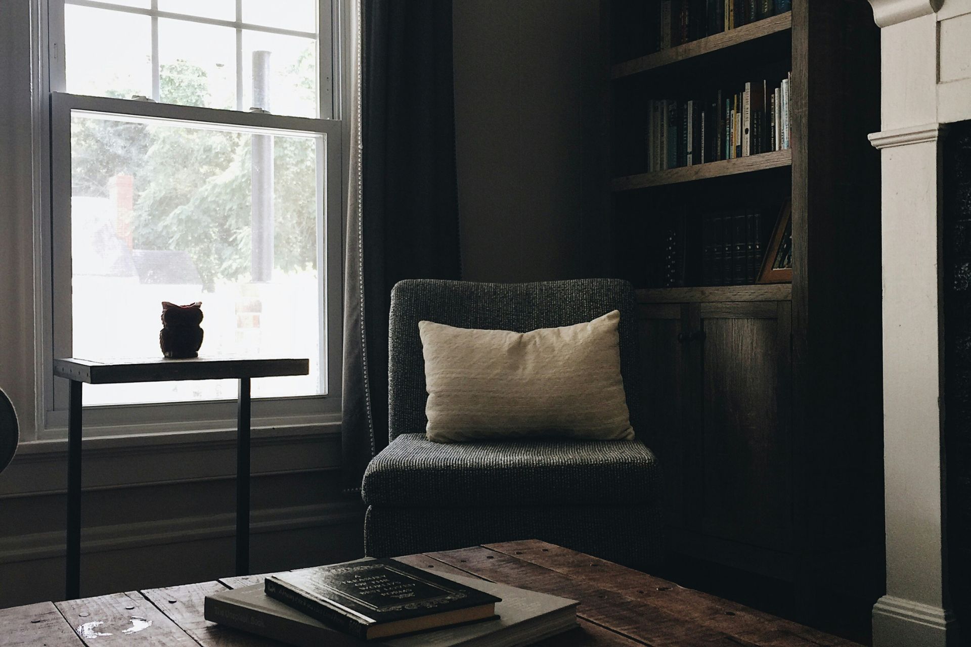 Living room with wooden coffee table and grey armchair