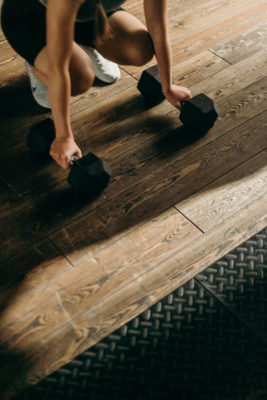 Woman picking up weights