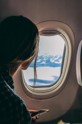 A woman looking out of an airplane window