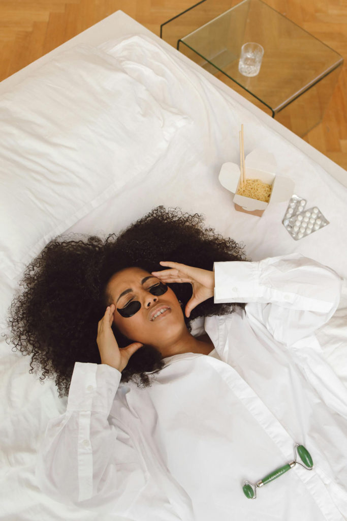 Woman with a hangover lying in bed