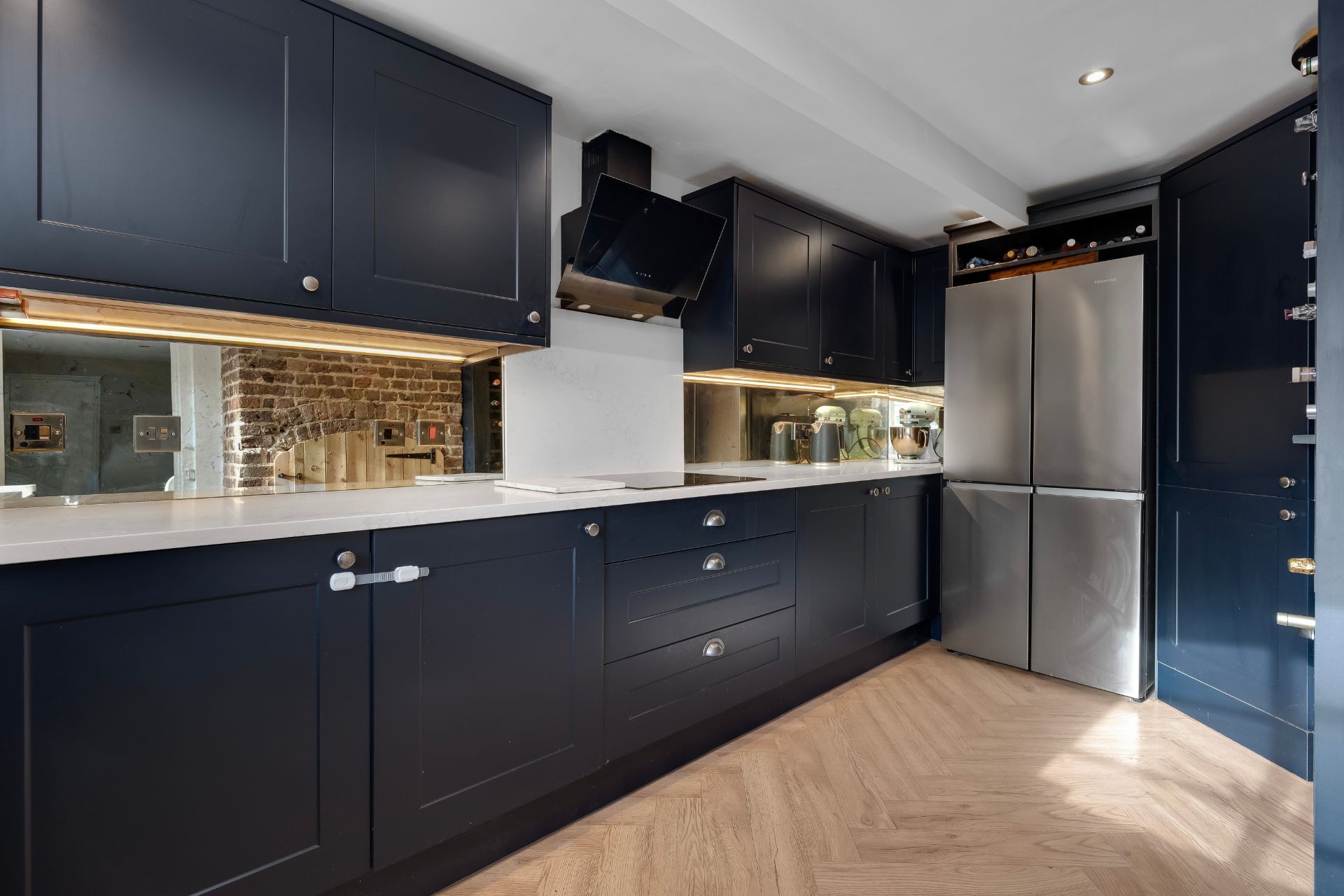 Modern kitchen with navy cabinets and white countertops