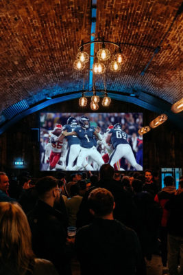 People watching rugby at Flat Iron Square