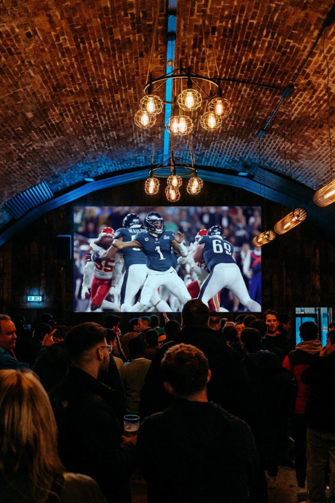 People watching rugby at Flat Iron Square