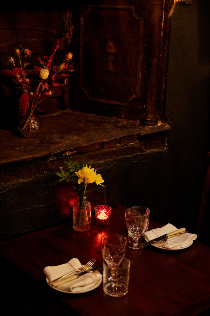 A dimly lit table with candles in a restaurant
