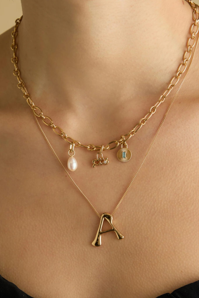 Close up of someone wearing aquarius jewellery