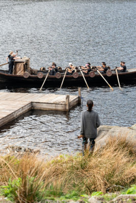 Claudia Winkleman in country outfit stood by boat
