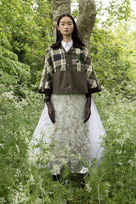 Woman in check coat and embroidered skirt