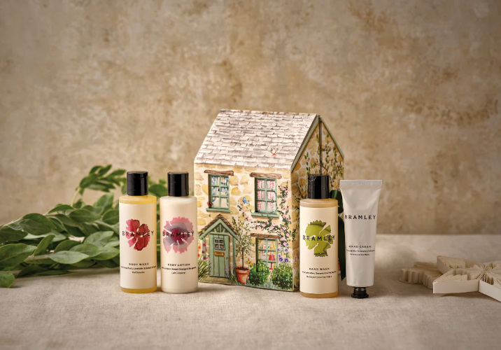 Beauty products in front of small ceramic house