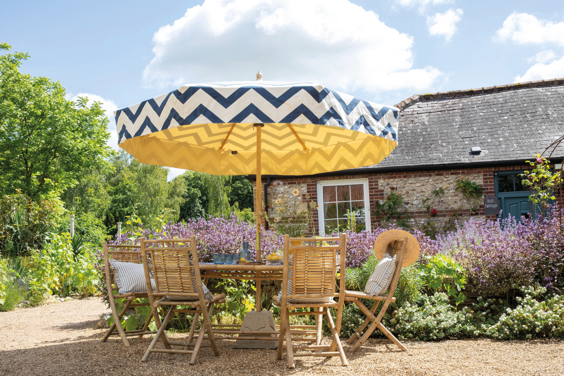 Blue umbrella with table and chairs