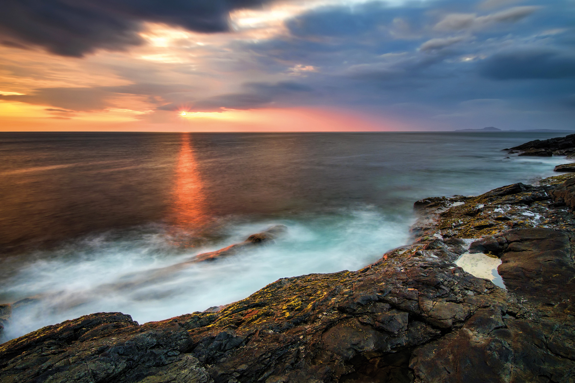 Rocky cliffs of Ardnamurchan Point in colorful sunset, Highlands, Scotland