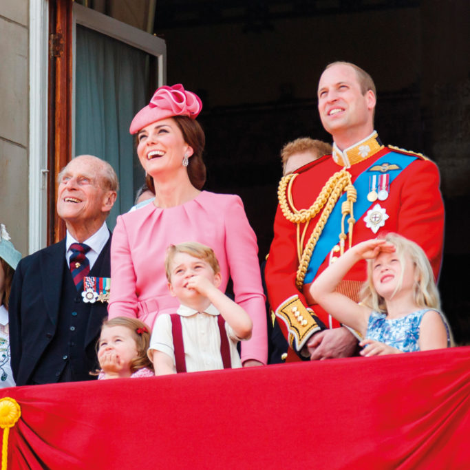 Kate Middleton and Prince William standing on a balcony