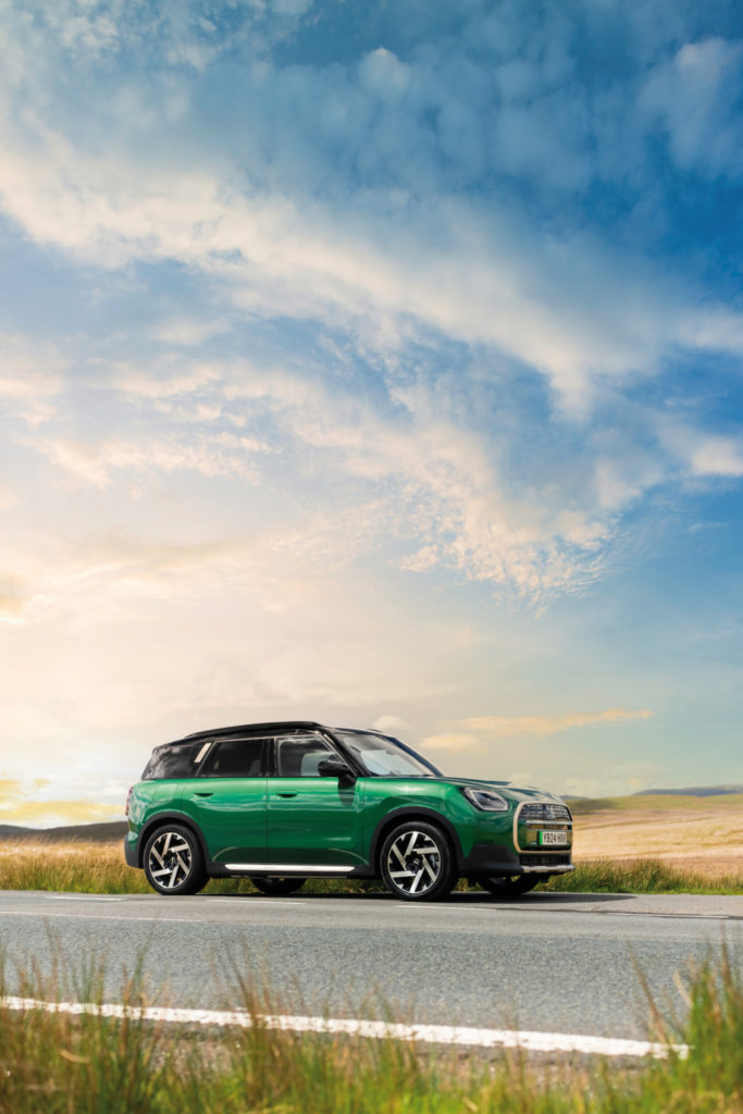 Green mini on road