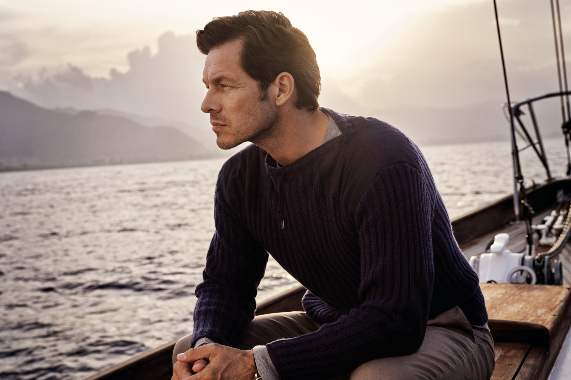 Man in jumper sat on boat