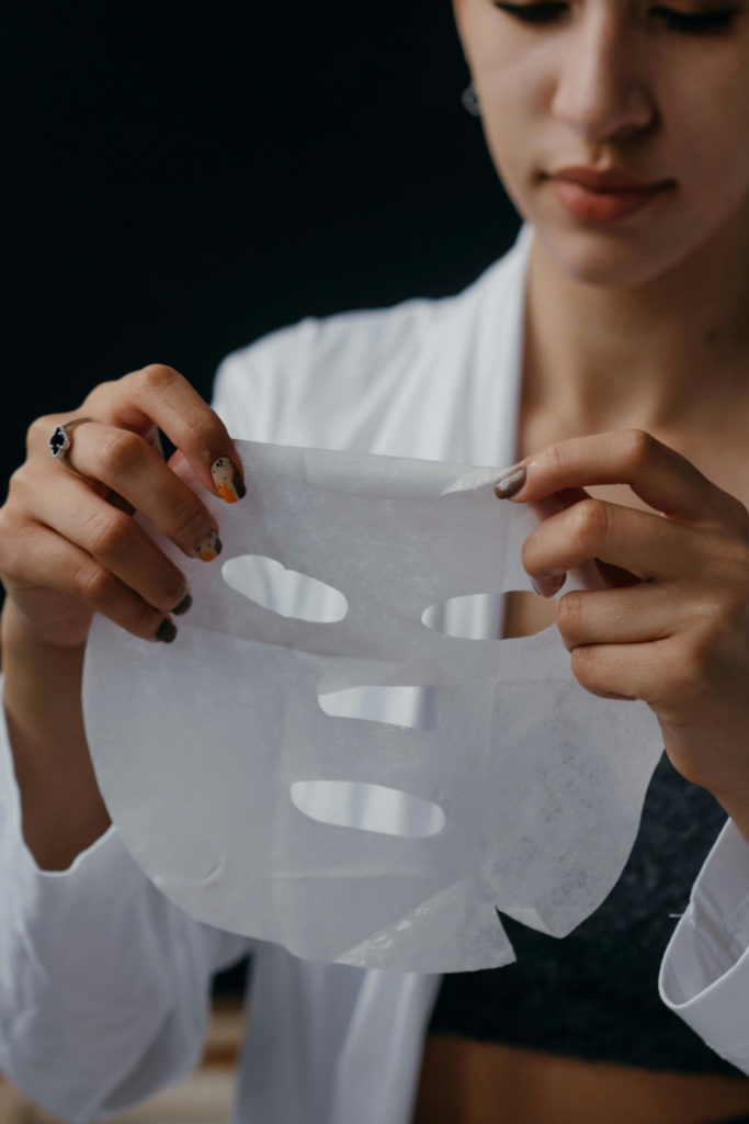 Woman holding up face mask | Korean skincare trends 2025
