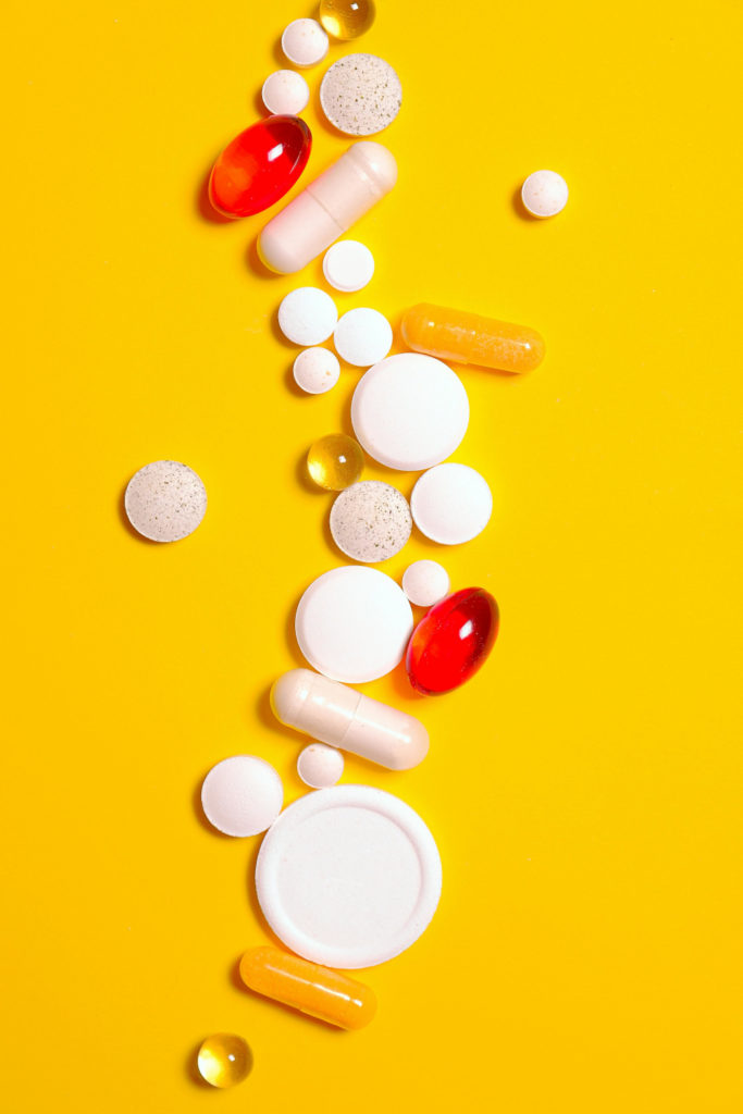 Tablets on yellow background | Supplements Guide