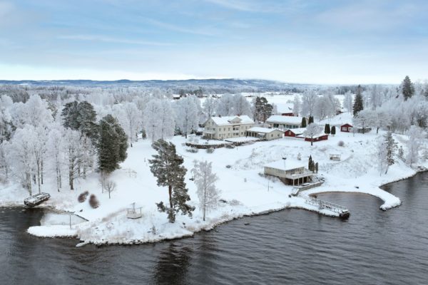 Aerial view of lakeside Stockhom estate with pool and lagoon-shaped beach