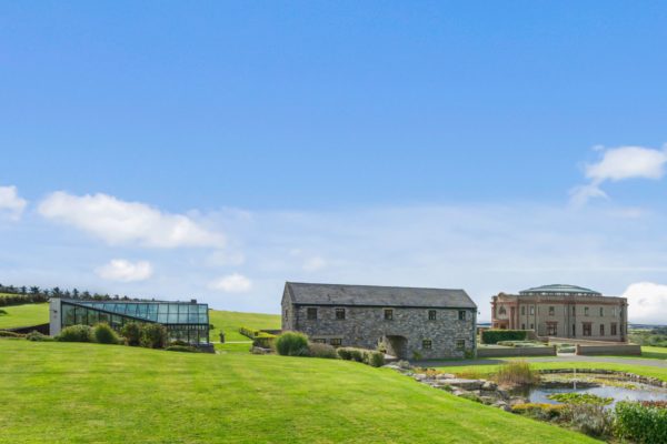 Isle of Man mansion including a stone farmhouse, a glass extension and a Palladian home
