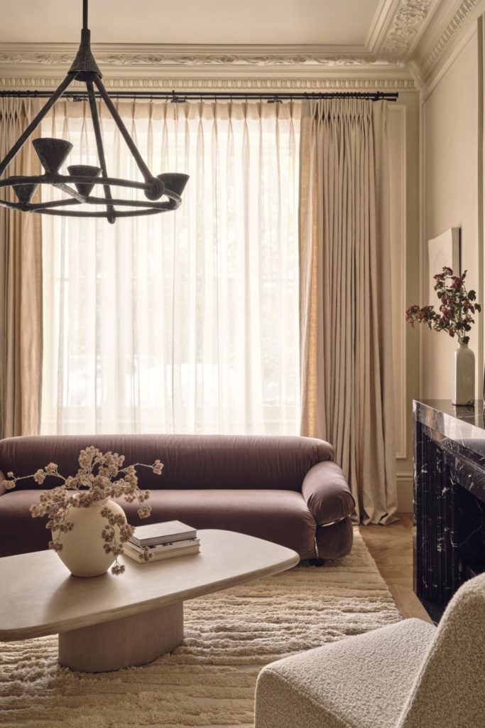 Curved purpe sofa and cream boucle armchair