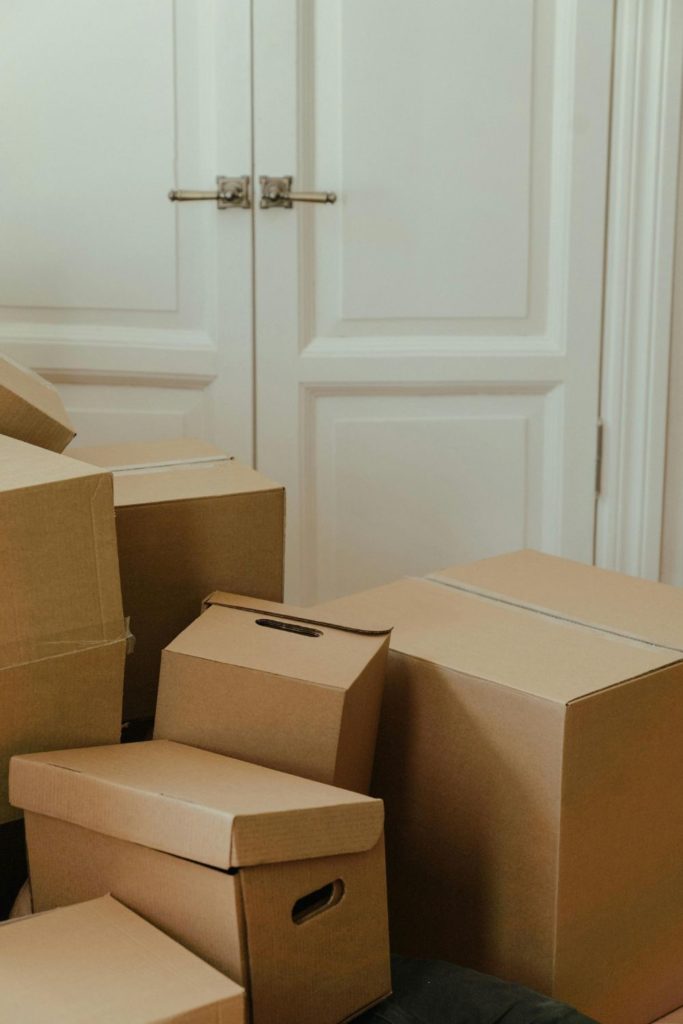 Piles of cardboard boxes against a white wardrobe