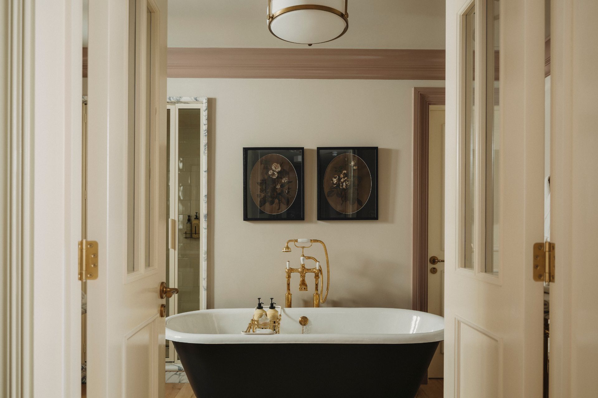 Hotel bathroom with freestanding bath and gold taps