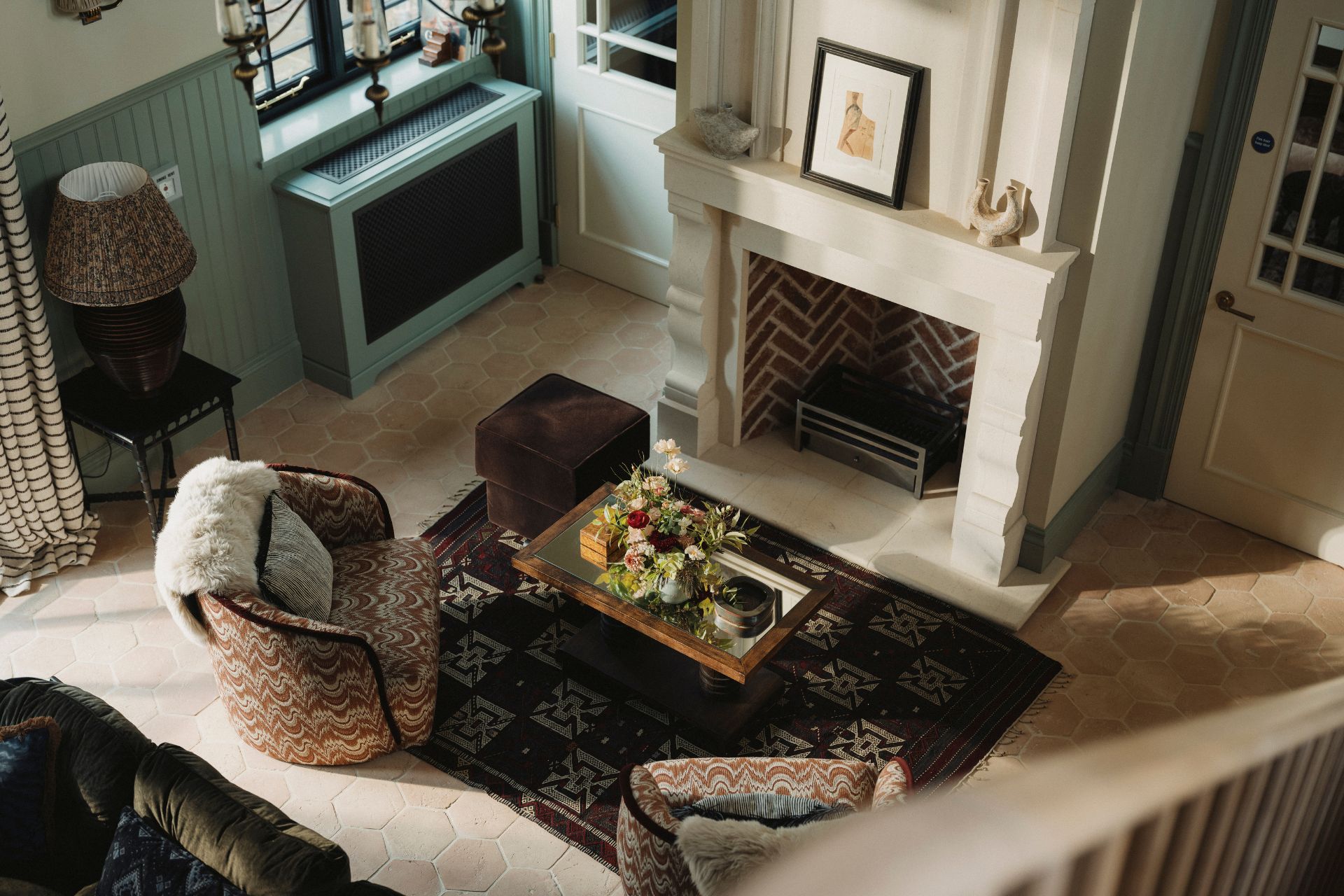 Aerial view of Estelle Manor lodge with marble fireplace and patterned armchairs
