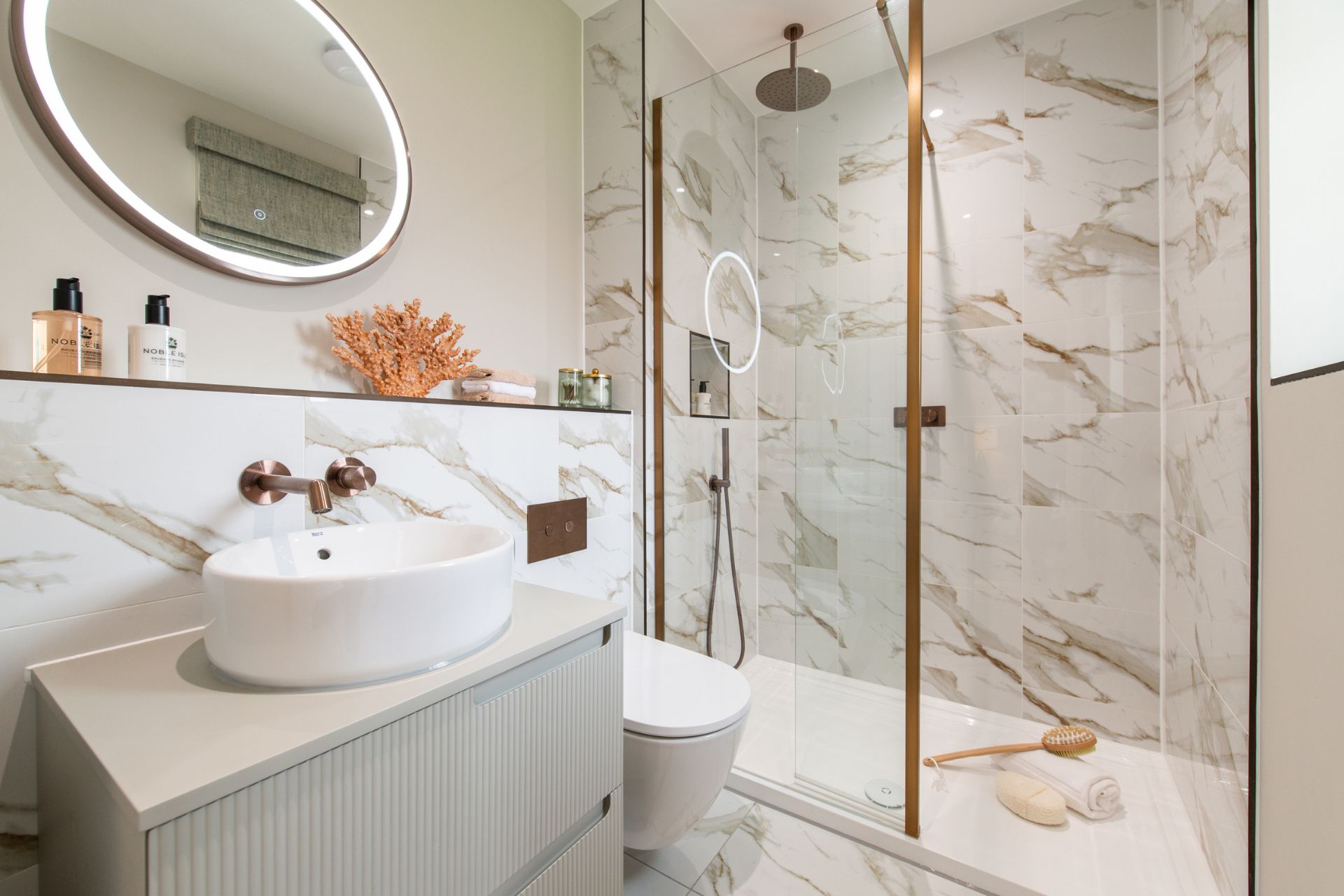 White marble bathroom with gold fixtures
