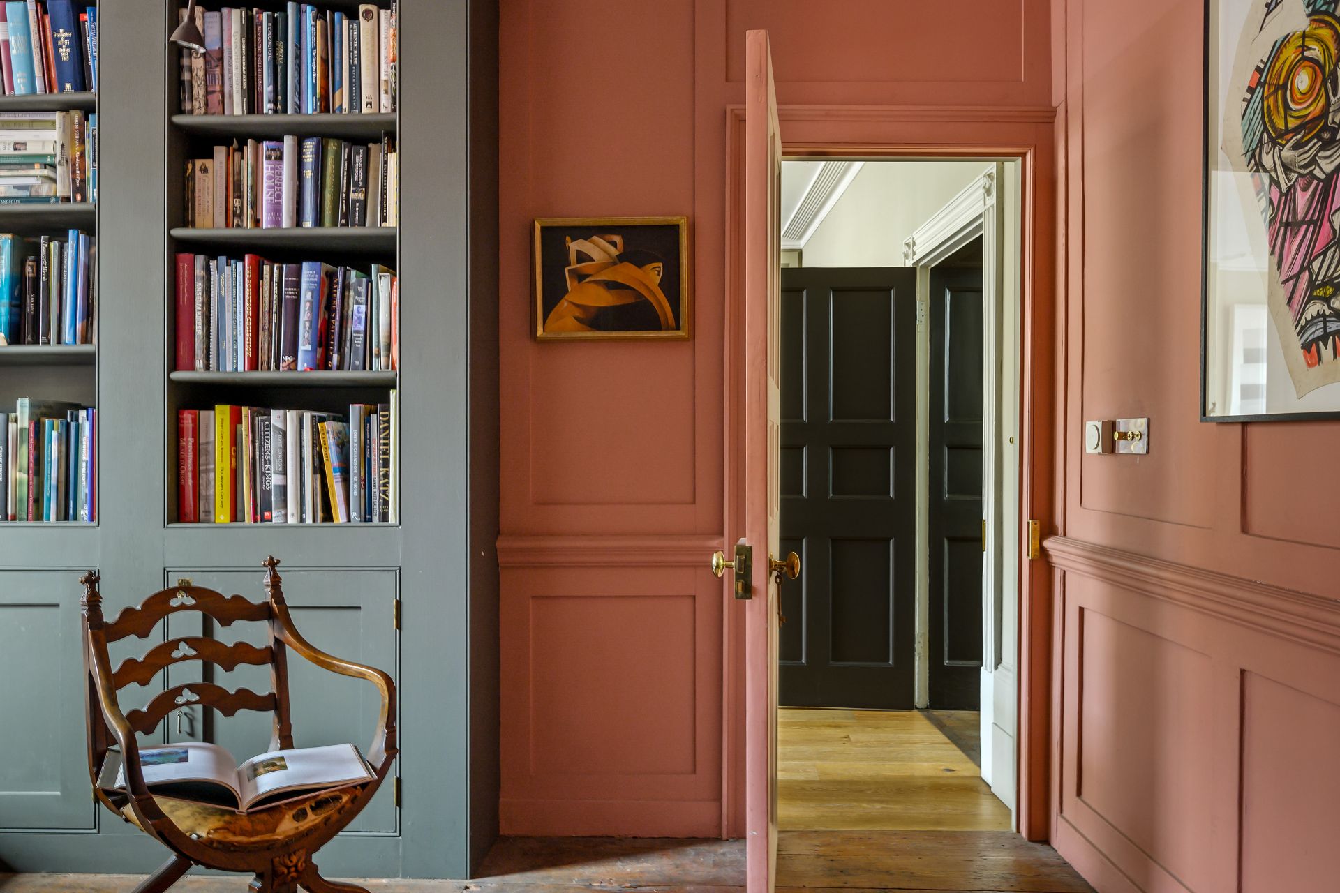 Terracotta living room with grey bookshelves