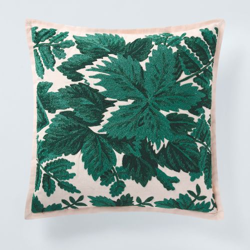 Cream cushion with a green botanical motif
