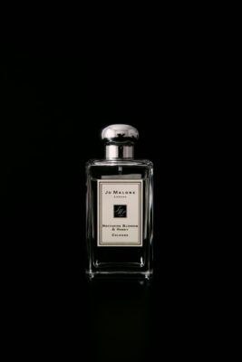 Jo Malone perfume bottle against black background
