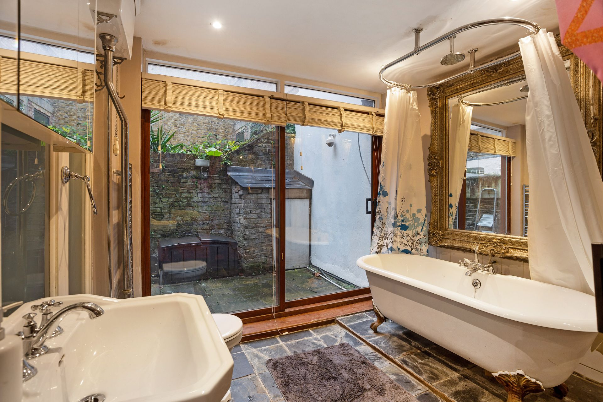 :arge bathroom with floor-to-ceiling windows and a freestanding bath.