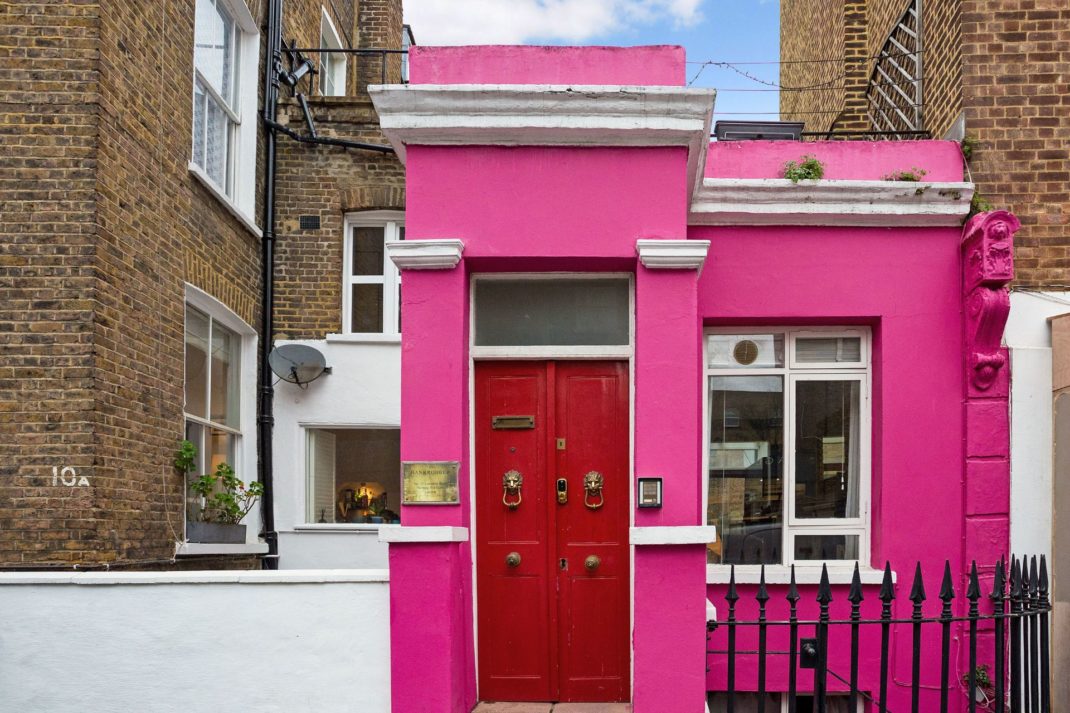 Bright pink Notting Hill with red painted door