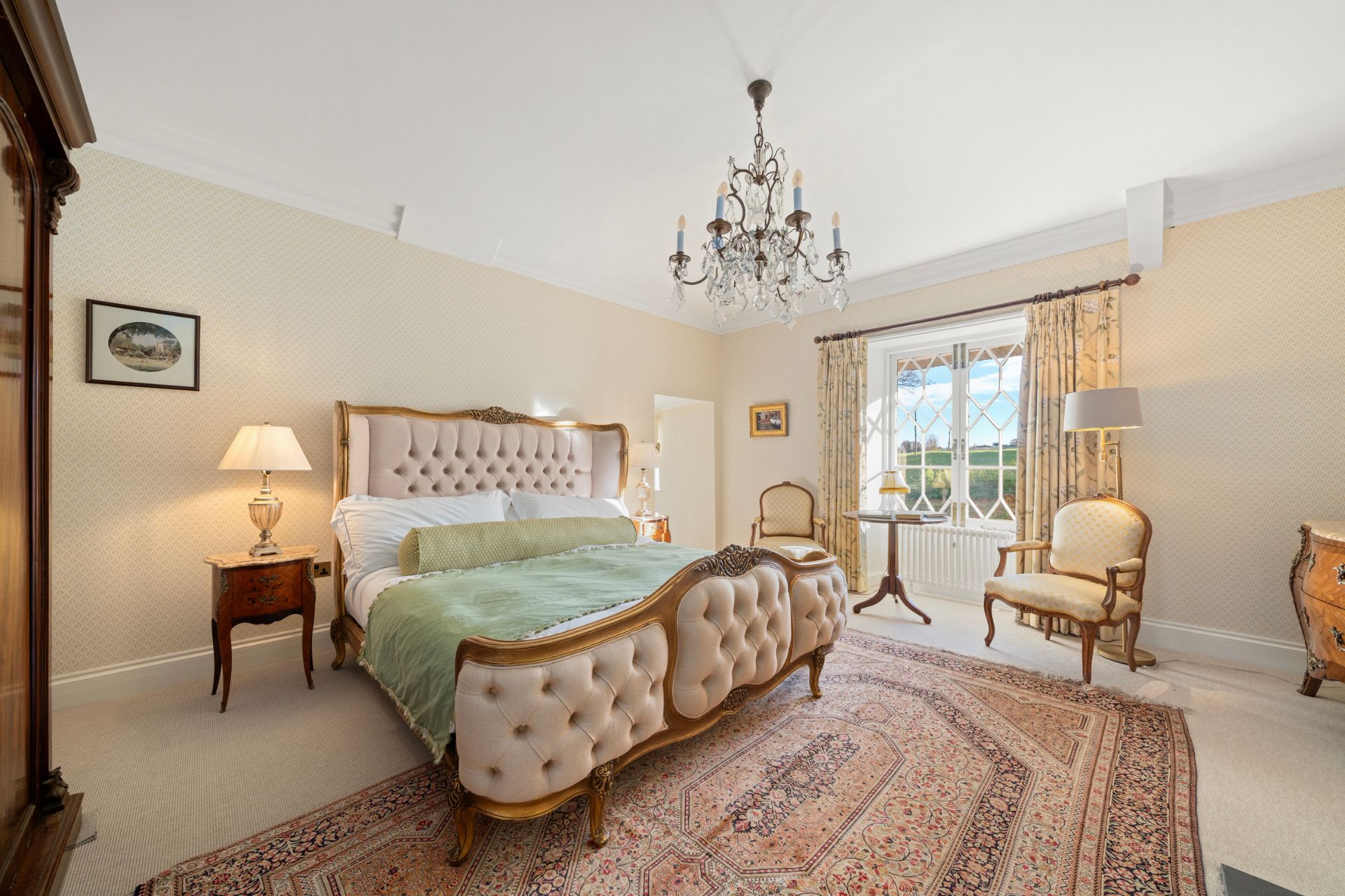 Bedroom with Parisian-style bed and chandelier