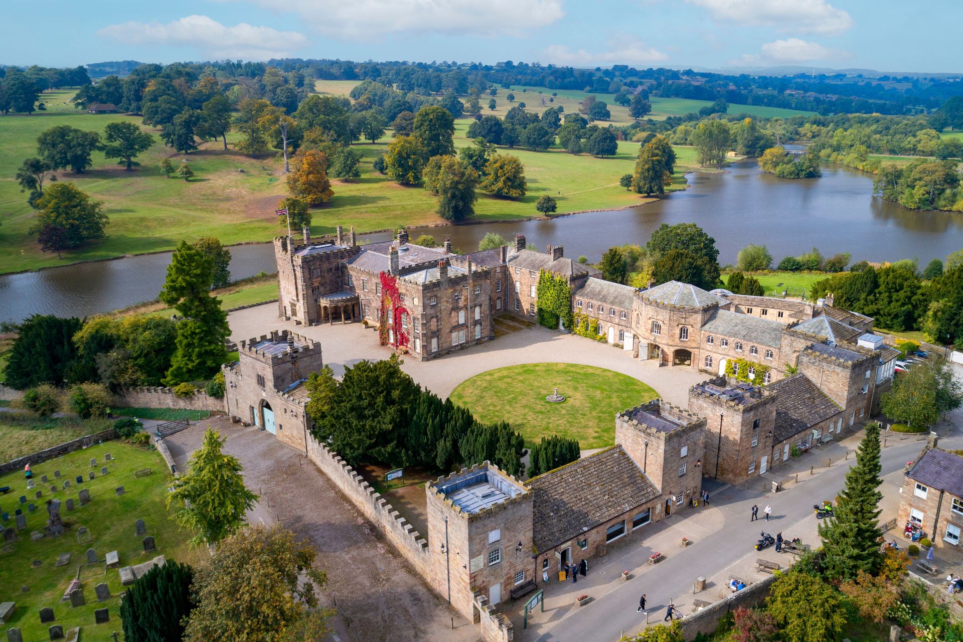 Aerial view of the Ripley Castle Estate, with a lake, circular garden and parkland