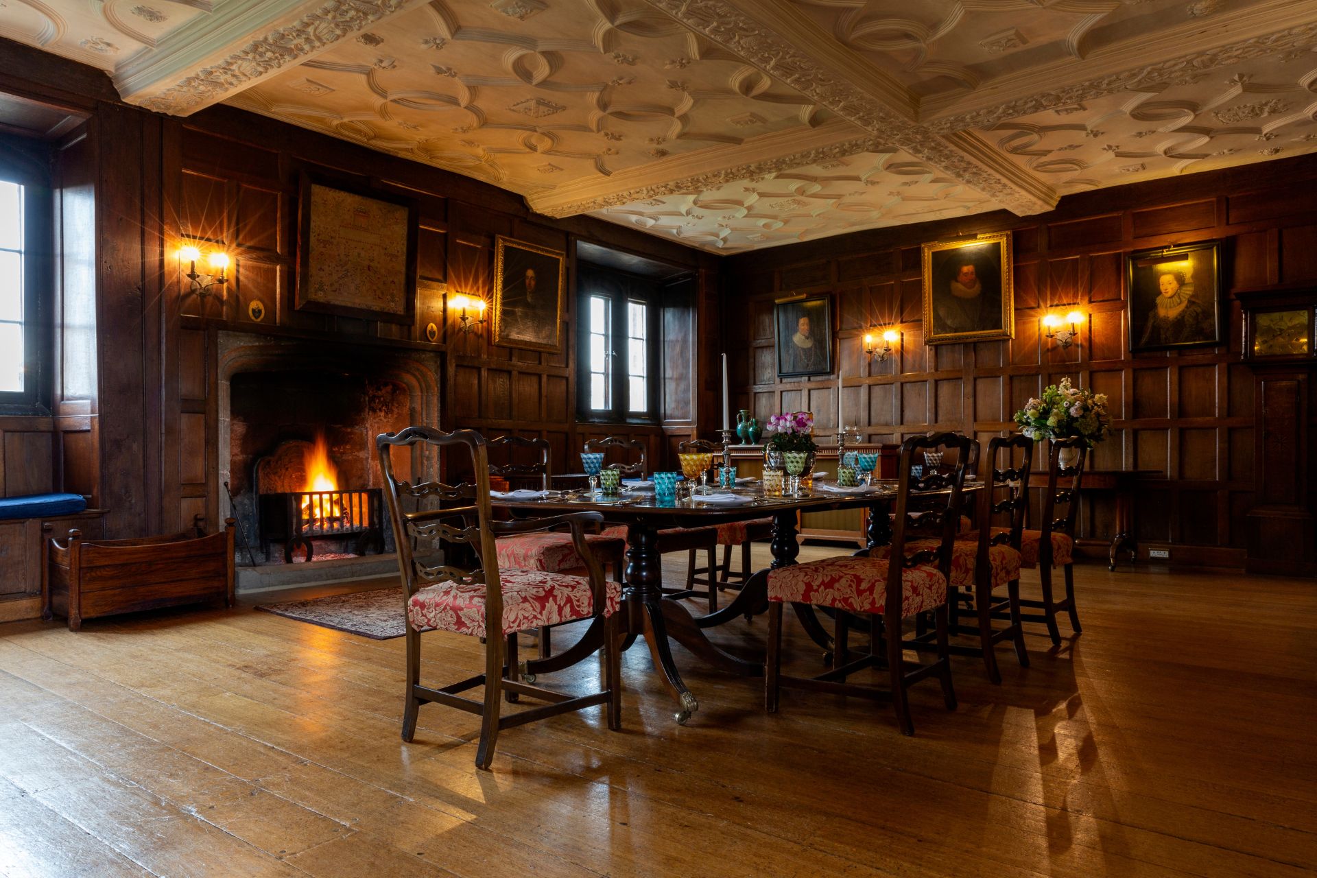 Castle dining room with mahogany furniture, oak floors and ceiling cornicing