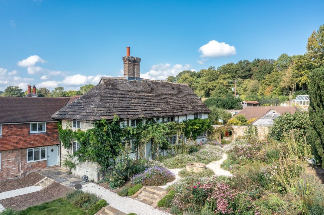 Farmhouse with ivy-covered exterior and wildflower gardens