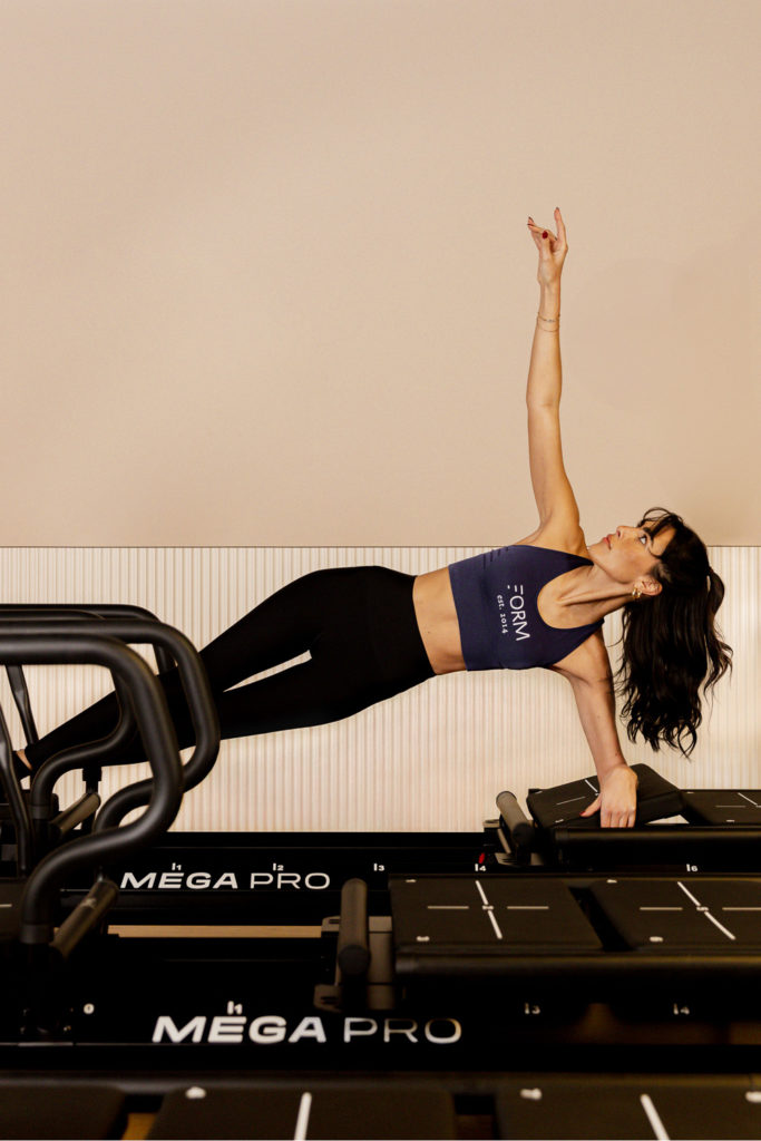 Woman doing a Lagree class