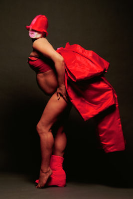 A model wearing a red outfit in the Leigh Bowery exhibition