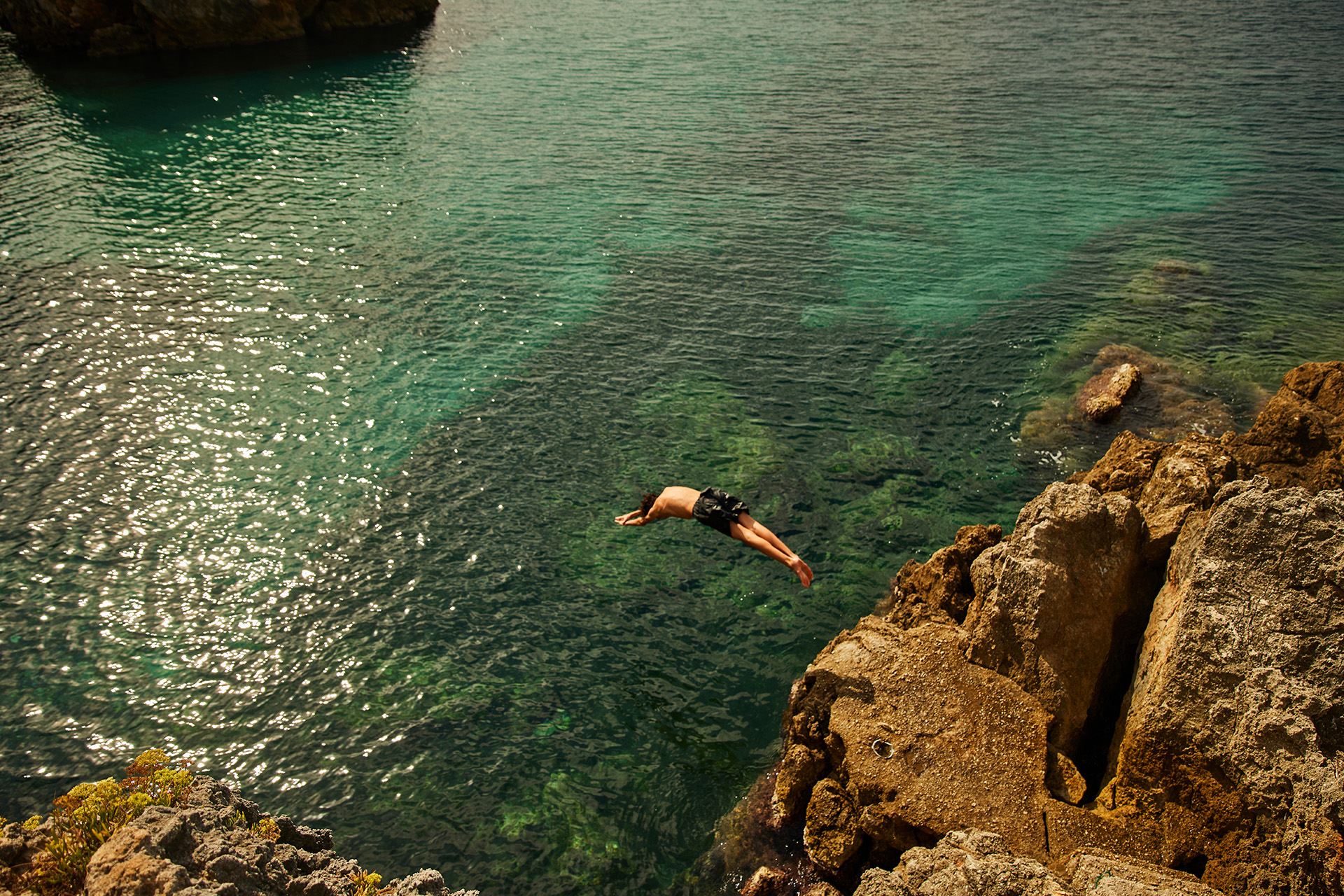 A teenager diving into the sea