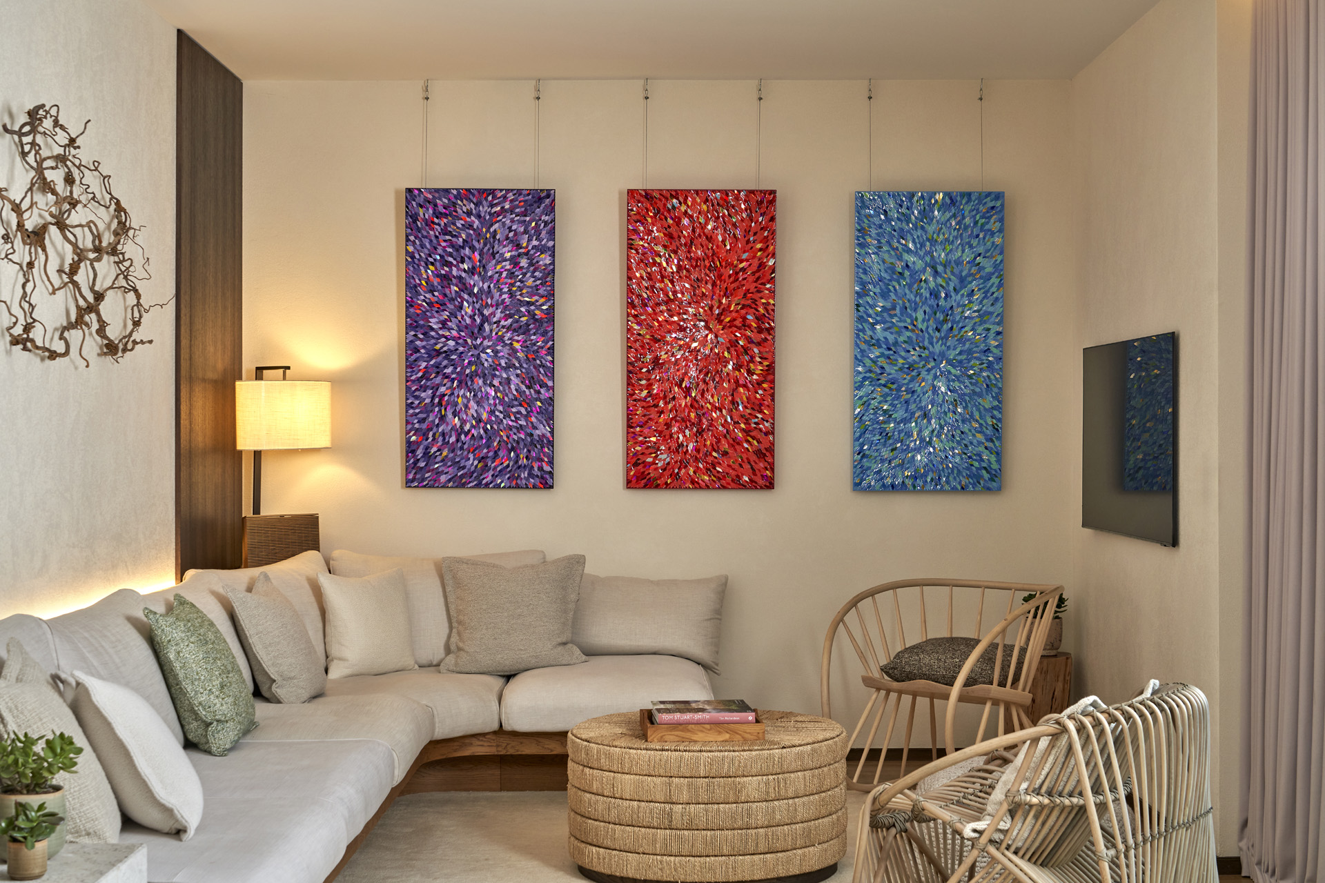 The sitting area in the suite with three paintings