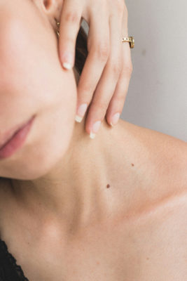 Woman touching neck | lymphatic drainage